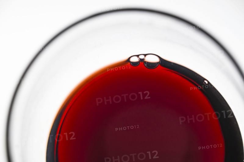 Glass of red wine on white background