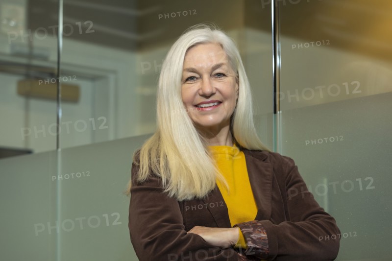 Portrait of smiling businesswoman with arms crossed