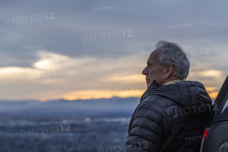Senior man looking at view during sunset