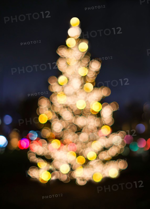 Defocussed Christmas tree illuminated at night