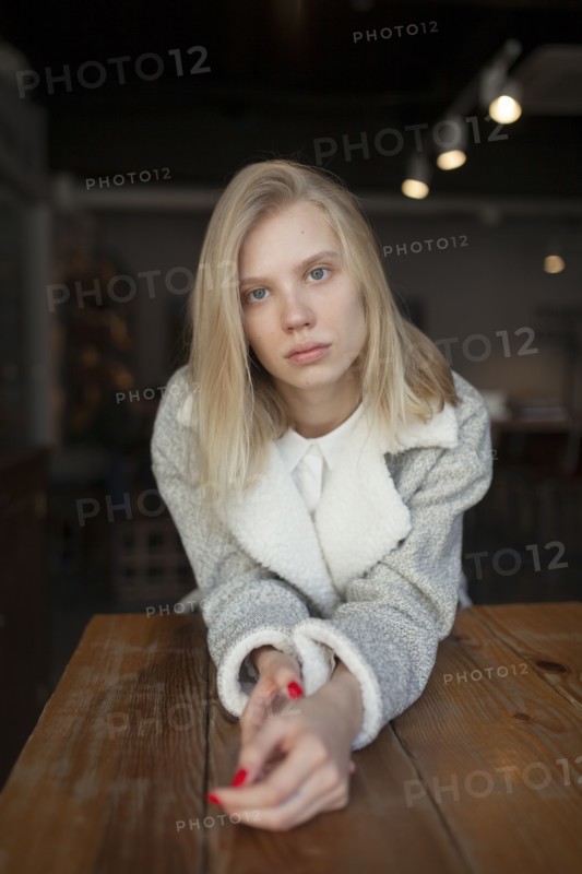 young woman sitting at cafe table