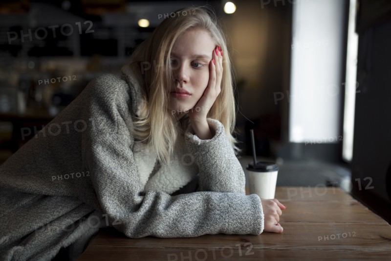 young woman sitting at cafe table