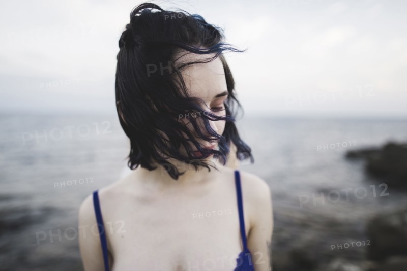 young woman on windy beach