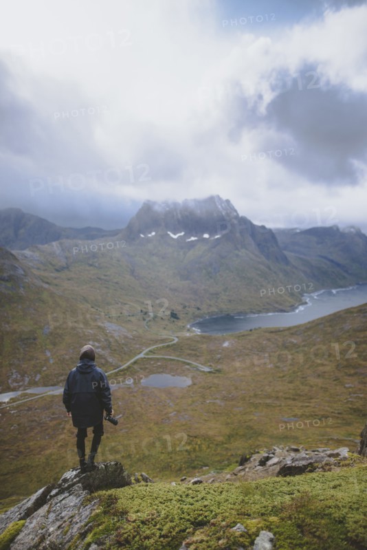 young man hiking on mountain in Norway