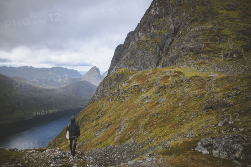 young man hiking on mountain in Norway