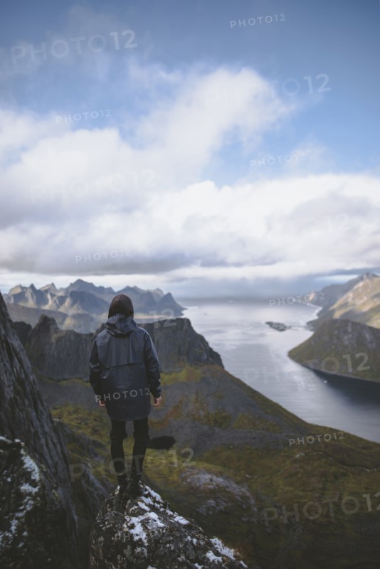 young man hiking on mountain in Norway