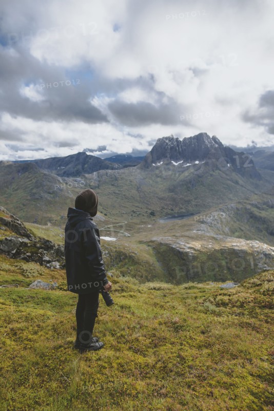 young man hiking on mountain in Norway