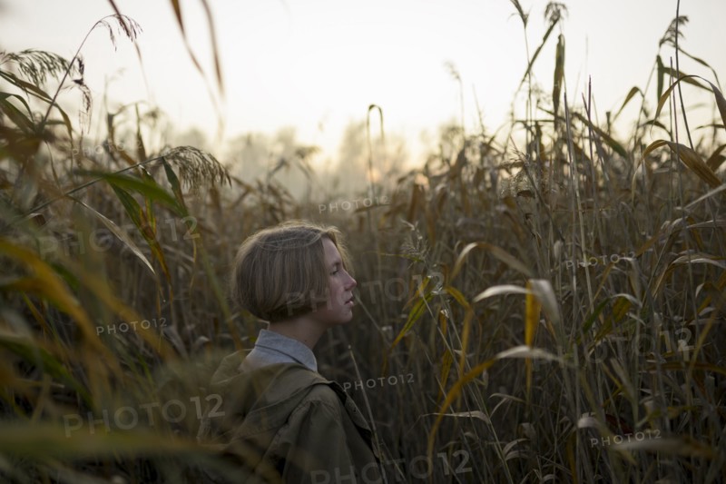 young woman in field of long grass