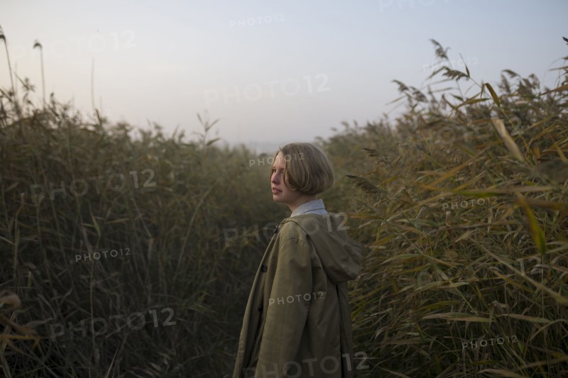 young woman in field of long grass