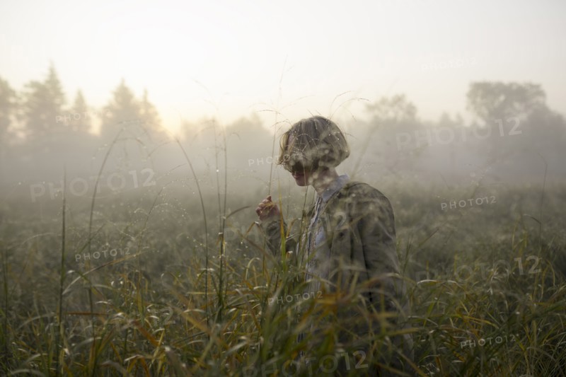young woman in field of long grass