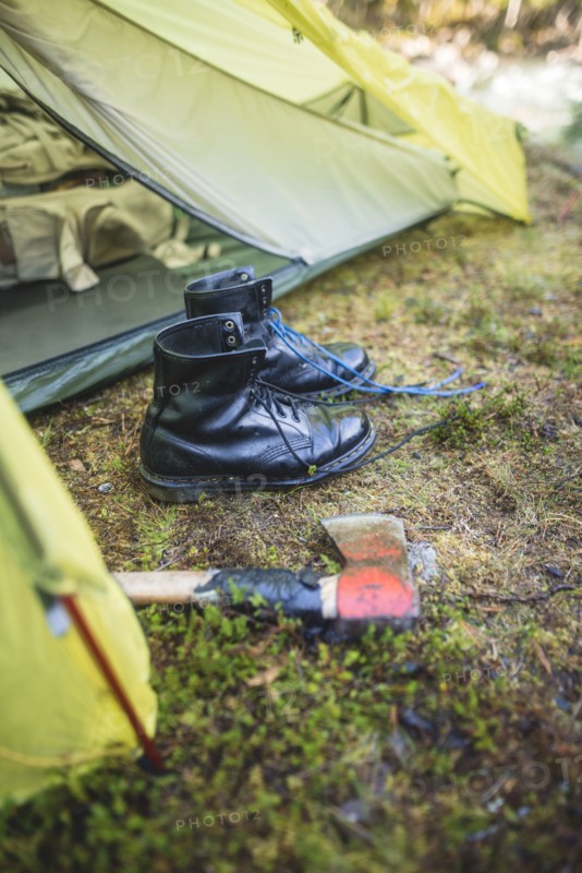 Boots and hatchet by tent