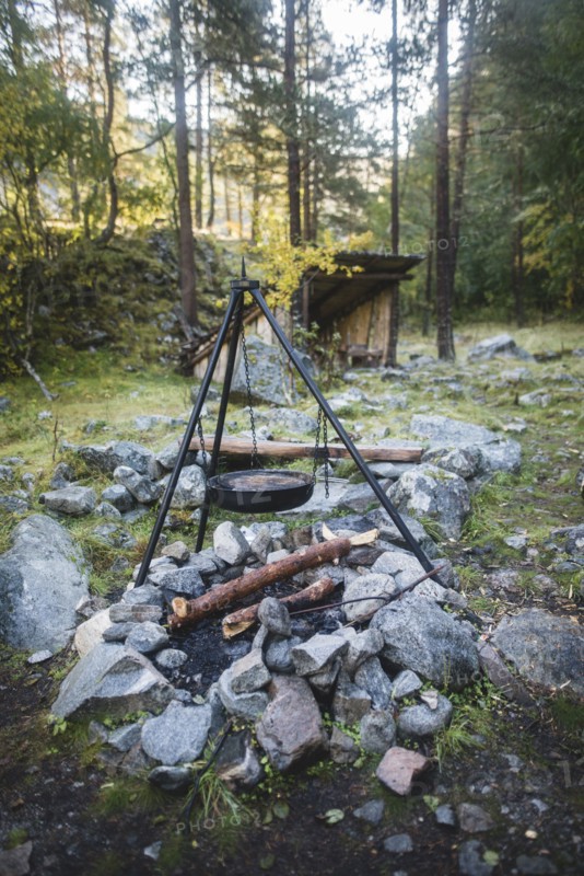 Cooking pot on tripod above campfire