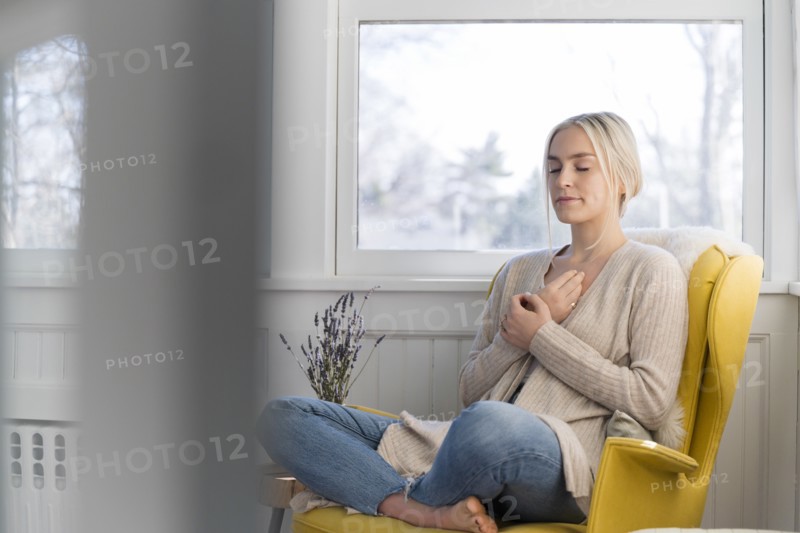 Woman meditating at home