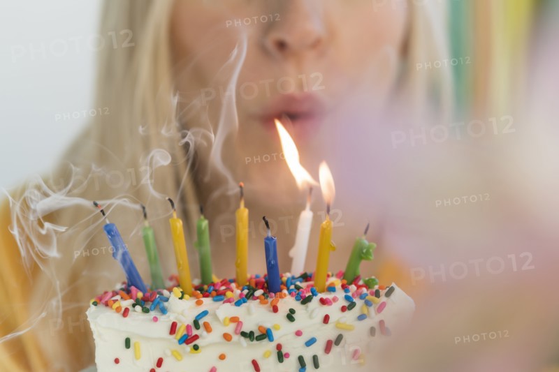 Woman blowing out birthday candles