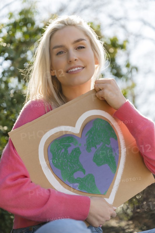 Woman holding climate change protest sign