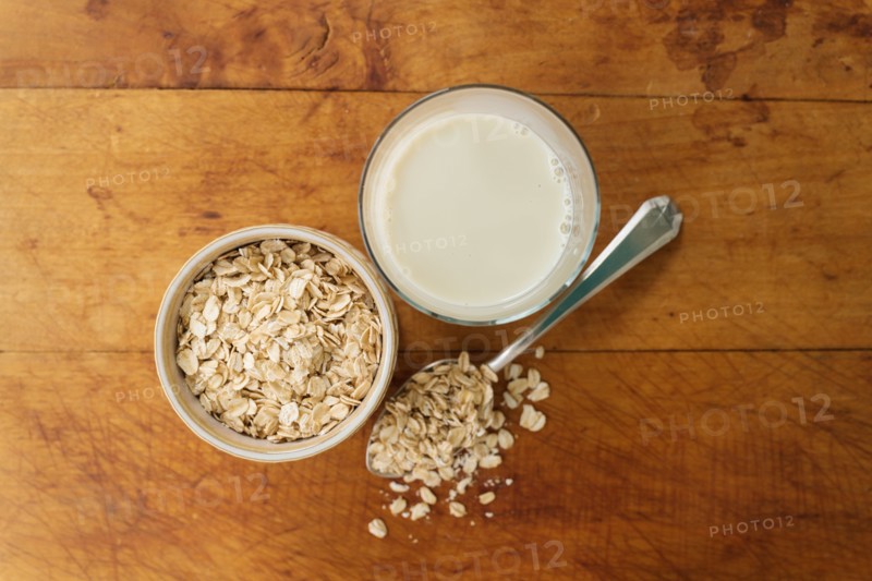 Oats and oat milk against wood