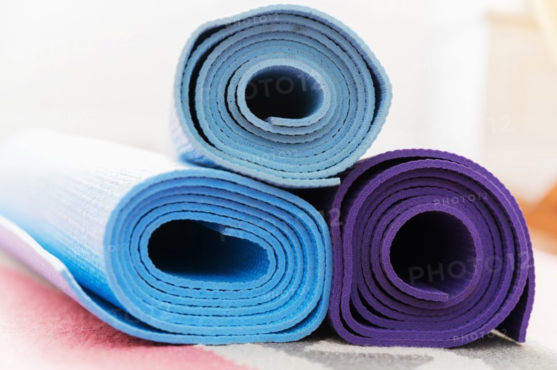 Pile of yoga mats on floor