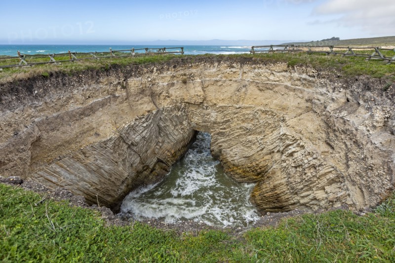 USA, California, San Luis Obispo, Sinkhole at edge of coastal bluff