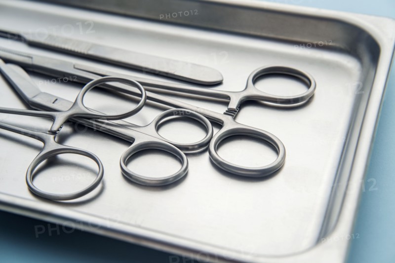 Forceps and scalpel on tray