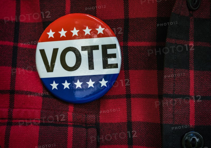 Vote button on red checked shirt