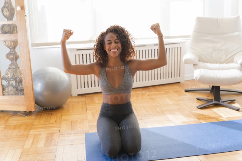 Smiling woman flexing her biceps