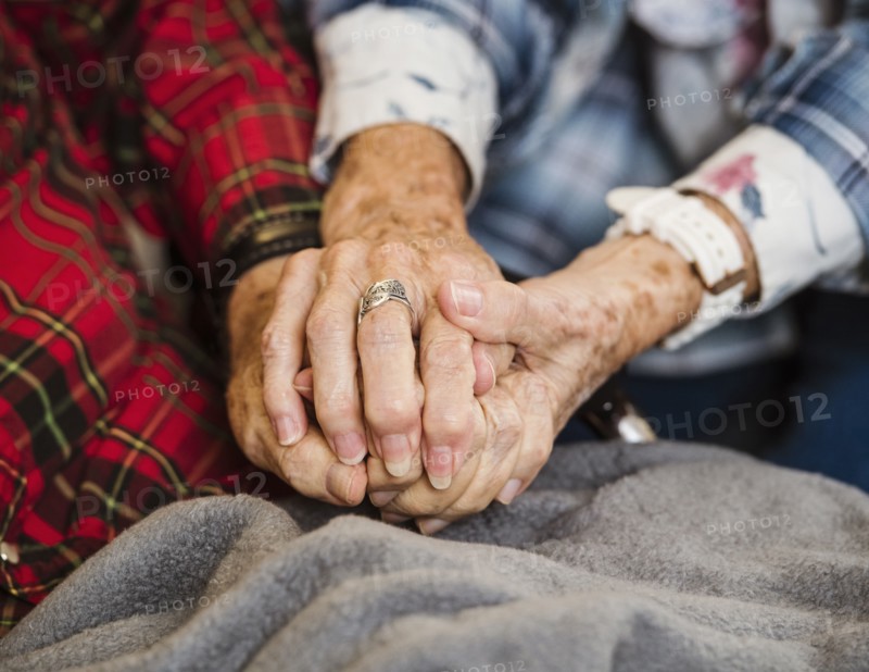 Senior couple holding hands