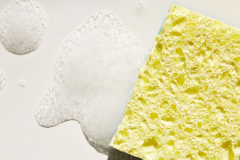 Yellow sponge and soap suds