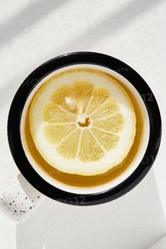 Lemon slice in cup of tea