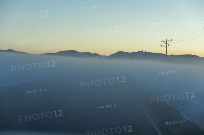 Road in fog at sunrise