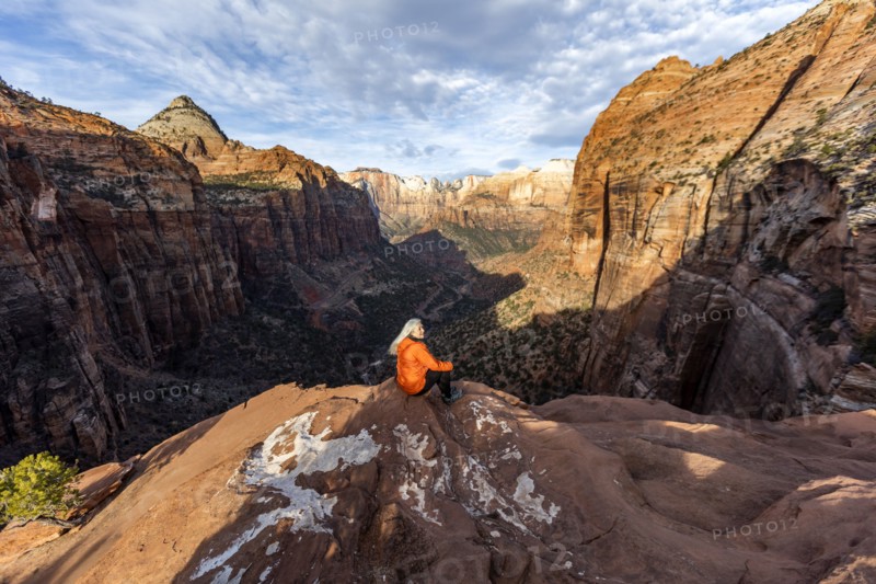 Woman sitting on cliff at Zion National Park in Utah, USA