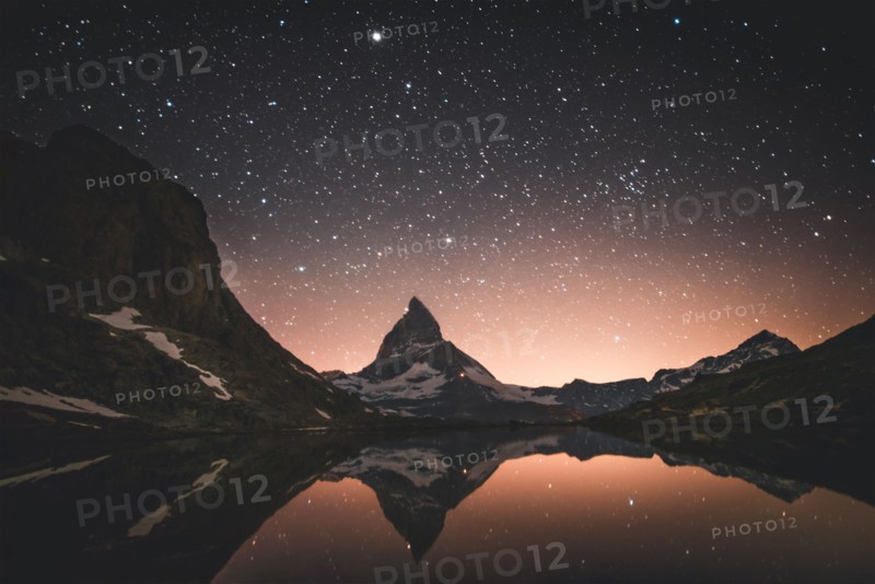 Matterhorn mountain and lake at night in Valais, Switzerland