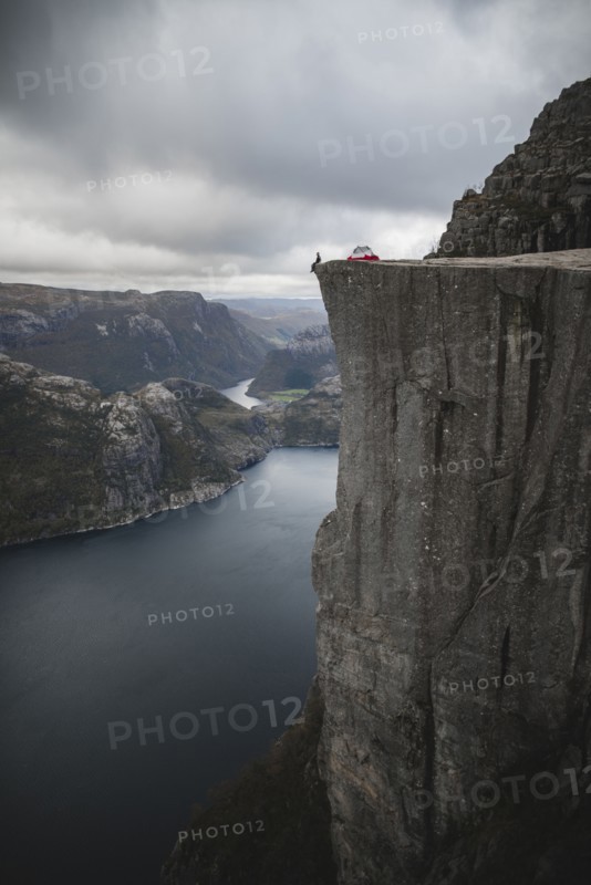 Person and tent on Preikestolen cliff in Rogaland, Norway