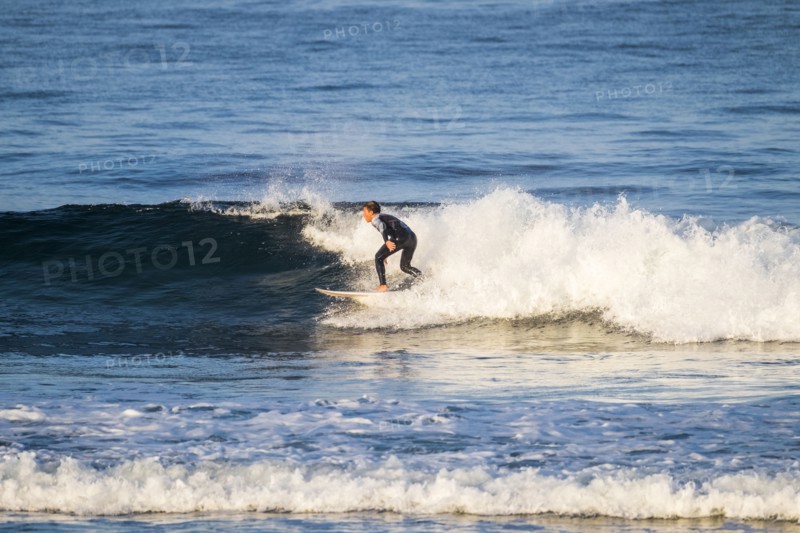 Teenage boy surfing waves