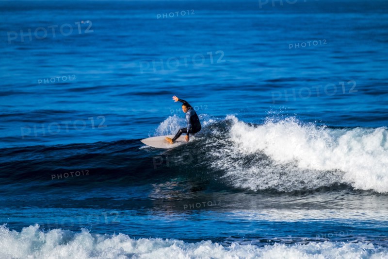 Teenage boy surfing waves