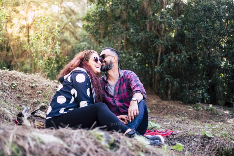 Smiling couple sitting on grass