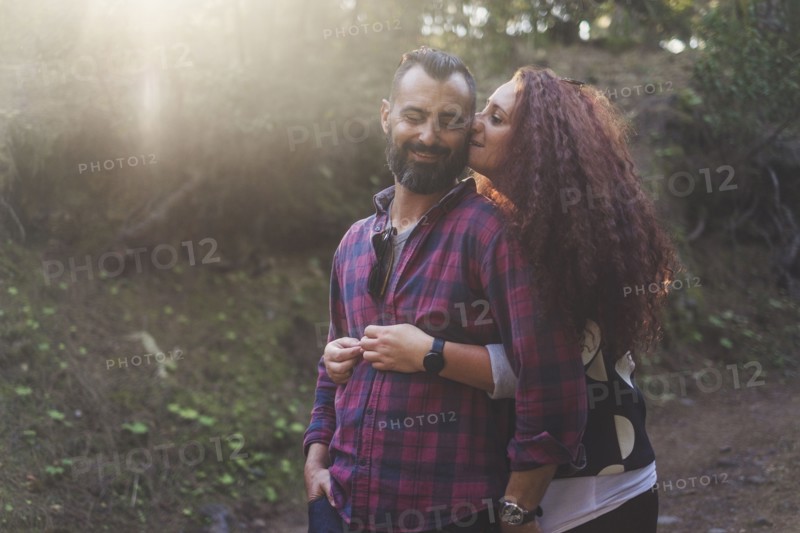 Smiling couple embracing in forest