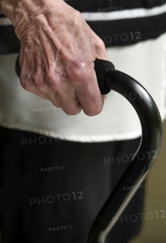 Close up of hand of senior woman holding cane