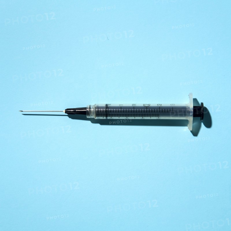 Syringe on blue background