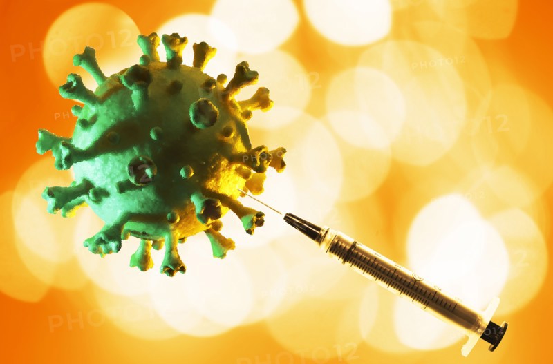 Model of Coronavirus with hypodermic needle
