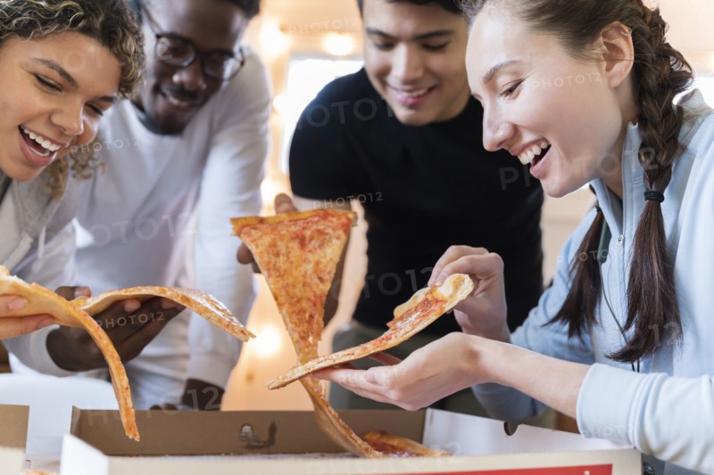 Group of friends having pizza together