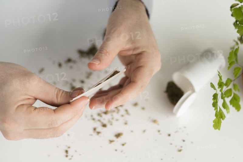 Close up of person rolling a joint