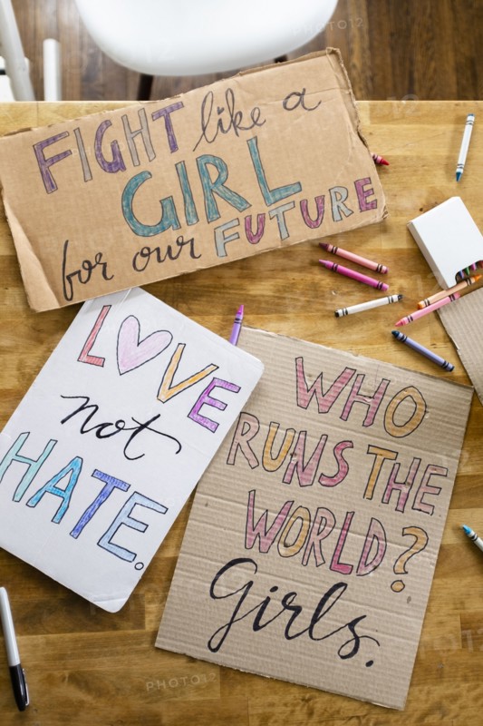 Women's march protest signs on table