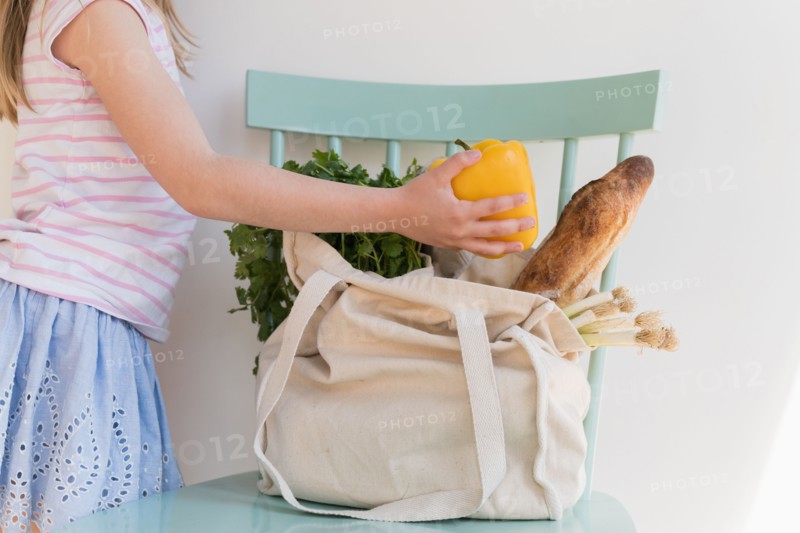 Girl unpacking products from reusable bag