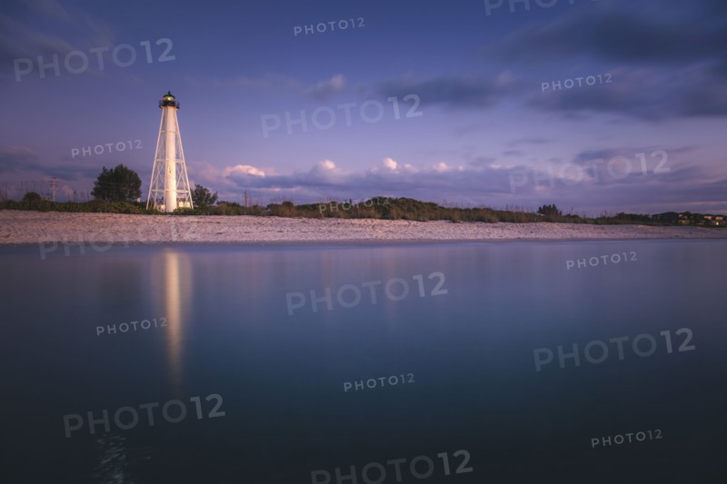 USA, Florida, Boca GrandeLighthouse reflecting in sea at night