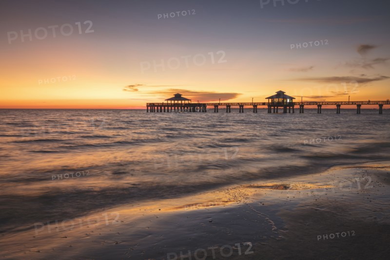 USA, Florida, Fort Myers Beach, Pier in sea at sunset