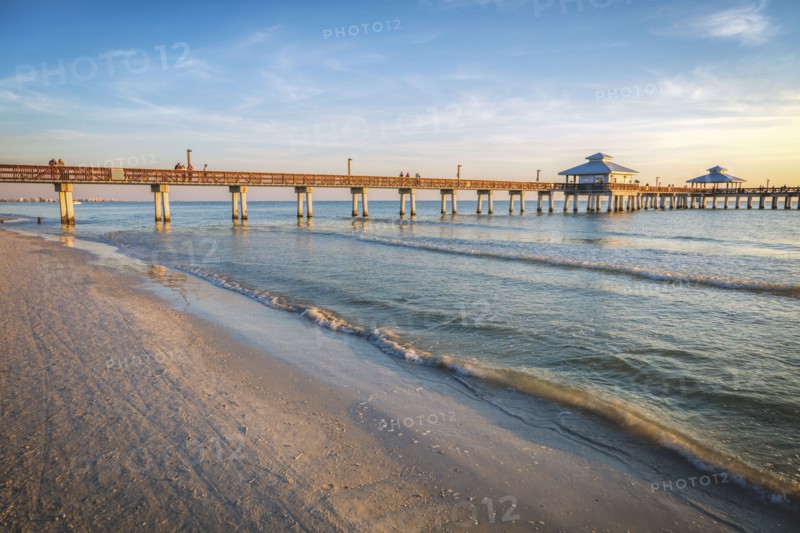 USA, Florida, Fort Myers Beach, Pier in sea at sunset