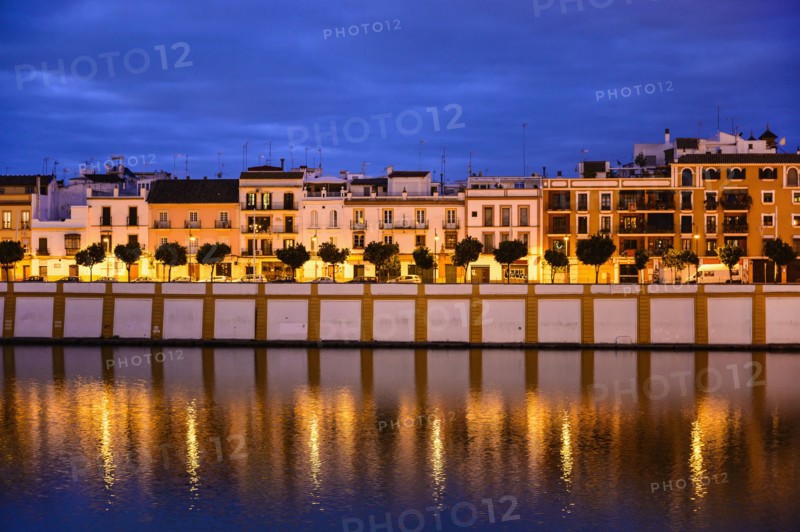 Spain, Seville, Triana, Triana neighborhood reflecting in Guadalquivir River