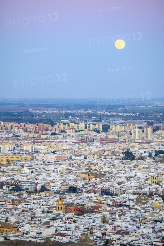 Spain, Andalusia, Seville, Moonrise over cityscape