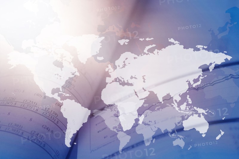 Digitally generated image of world map with financial data in background