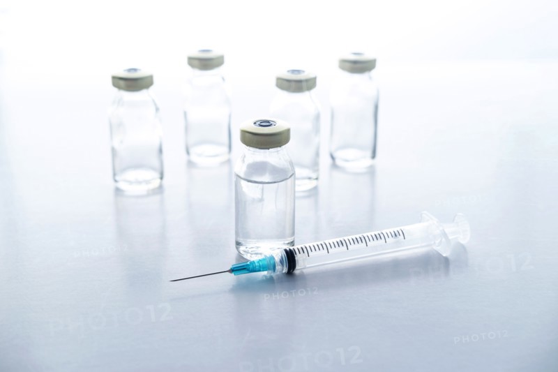 Studio shot of vials and syringe